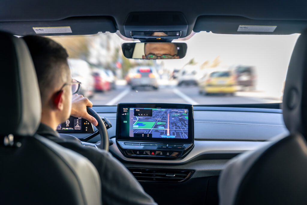 Man driving a car with GPS navigation system