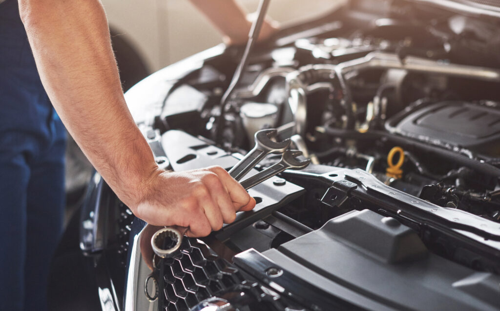 man inspecting car